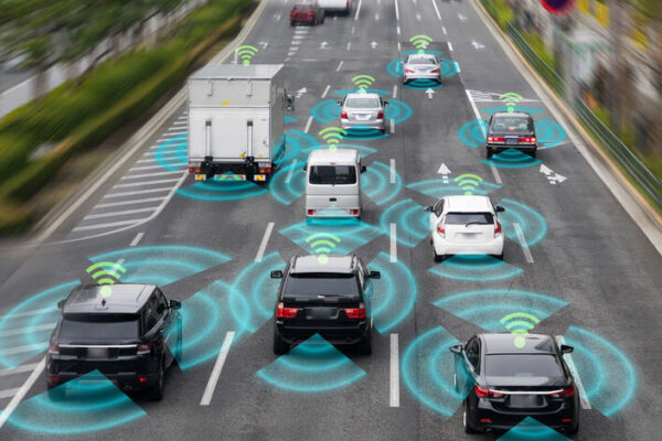 Autonomous vehicle navigating a busy Texas street with skyscrapers in the background