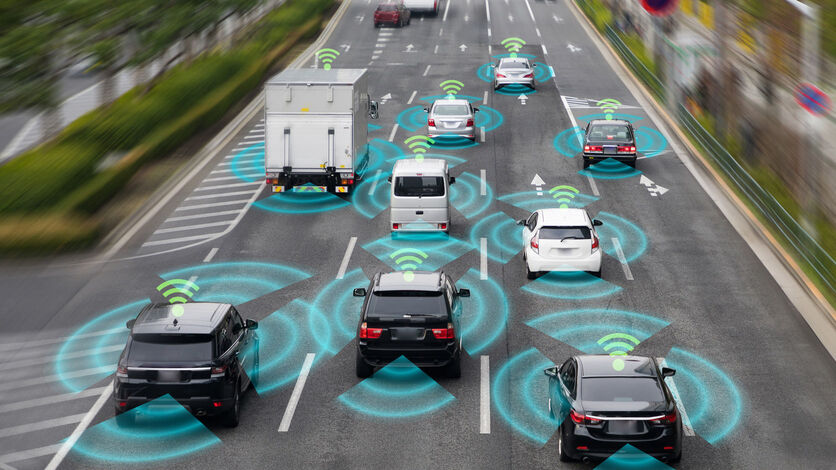 Autonomous vehicle navigating a busy Texas street with skyscrapers in the background