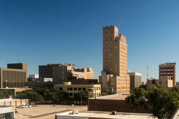 Lubbock Texas city skyline with financial charts overlay