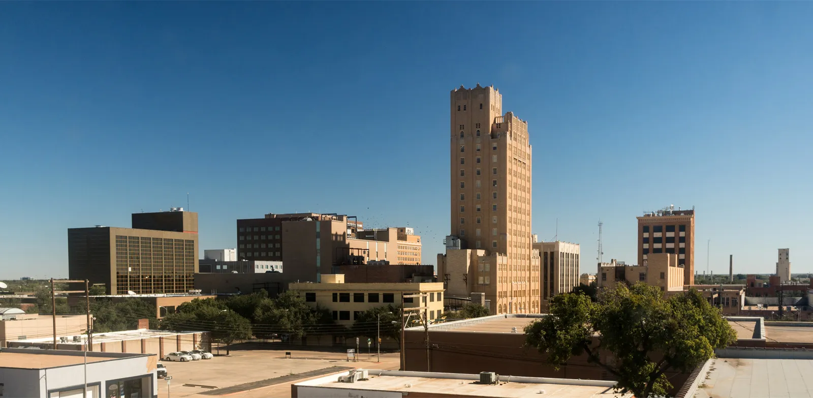 Lubbock Texas city skyline with financial charts overlay